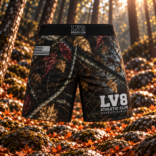 Front view of men's LV8 Woods shorts with woodland camouflage, a black LV8 waistband, monochrome American flag, and gray leg branding.
