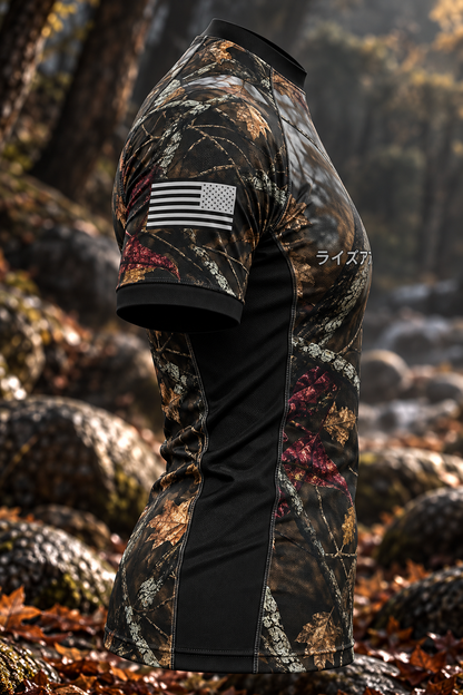 Right side view of the men's Woods rashguard showing woodland camouflage, a monochrome USA sleeve flag, and a black side panel