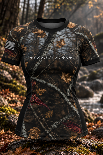 Front view of the women's Woods rashguard with woodland camouflage, black trim and Japanese chest lettering
