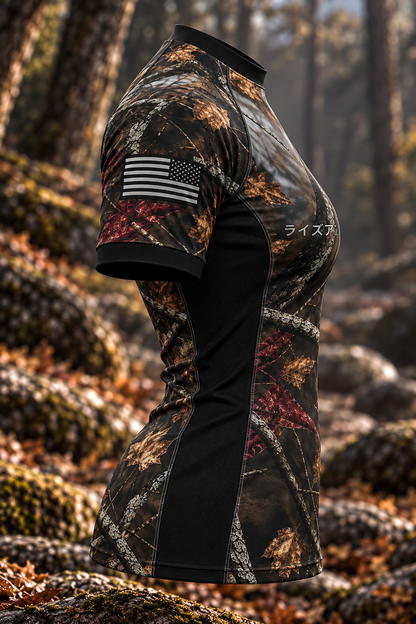 Side view of the women's Woods rashguard showing woodland camouflage, a monochrome USA sleeve flag and a black side panel