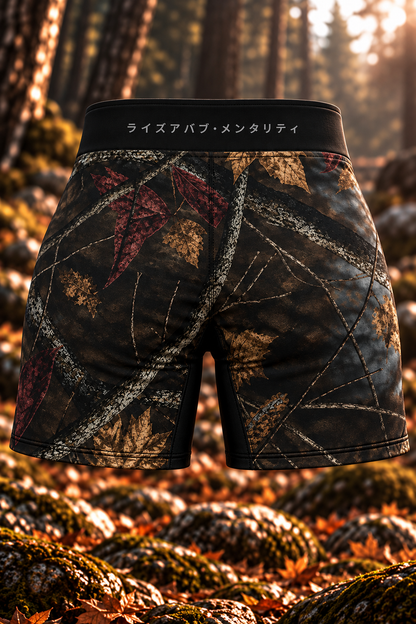 Back view of women's LV8 Woods shorts showing woodland branch-and-leaf camouflage and Japanese lettering across the black waistband.